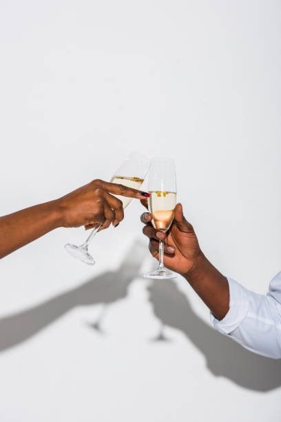 Two people raising glasses in a toast